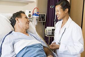 Doctor And Patient Talking To Each Other, Smiling