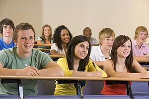 Students in class paying attention and taking notes (depth of field)