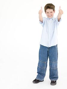 Young boy giving thumbs up smiling