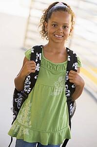 Student standing outdoors smiling (high key)
