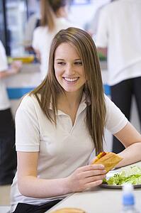 Student having lunch in dining hall