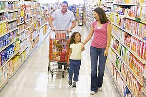 Mother and father with young daughter shopping for a new car