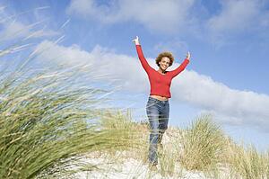 Young woman posing on a sand hill