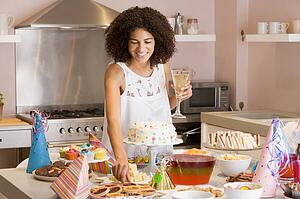 Woman at party getting tart from table smiling