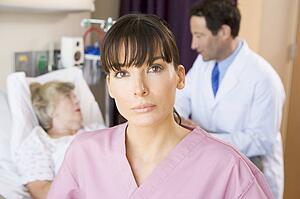 Nurse Standing In Hospital Room, Doctor Talking To Patient