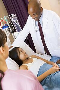 Doctor Talking To Young Girl