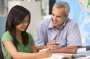 Teacher giving personal instruction to female student