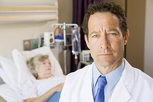 Doctor Standing In Patients Room