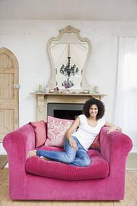 Woman sitting in living room smiling