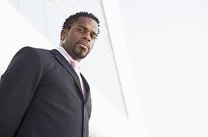 Businessman standing outdoors by building