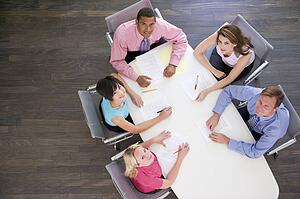 Five businesspeople at boardroom table