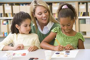 Two students in art class with teacher