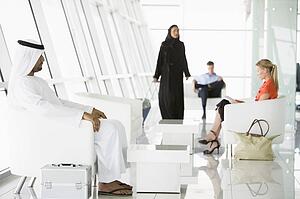 Airline passengers waiting in departure gate