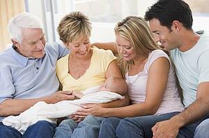 Family in living room with baby smiling