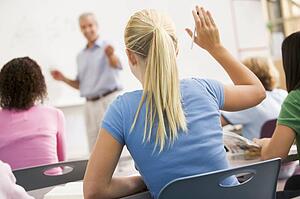 Students answering questions in math class with teacher