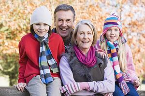 Grandparents with grandchildren outdoors in park smiling (selective focus)