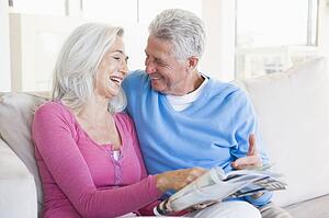 Couple with a magazine smiling