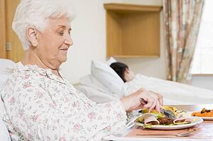Senior Woman Eating Hospital Food