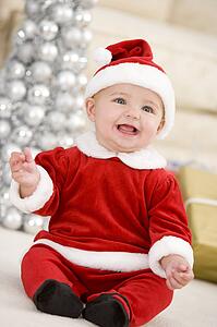 Baby In Santa Costume At Christmas