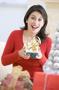 Woman Excited To Open Christmas Present