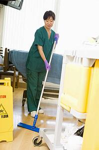 An Orderly Mopping The Floor In A Hospital Ward