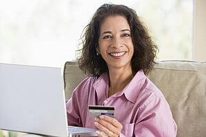 Woman with a laptop computer making an online purchase with credit card
