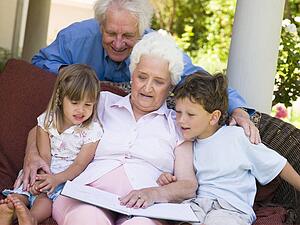 Grandparents reading to grandchildren.