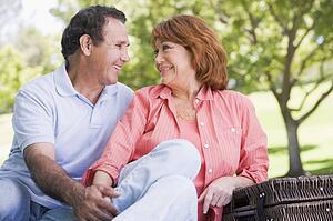 Couple at a picnic holding hands and smiling