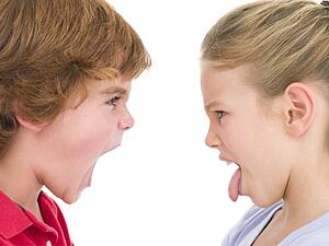 Brother shouting at sister sticking her tongue out