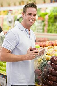 Man shopping for apples at a grocery store
