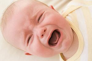 Baby lying indoors crying