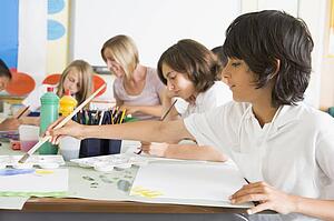 Students in art class with teacher (depth of field)