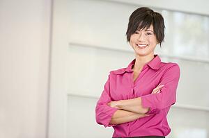 Businesswoman standing indoors smiling