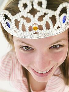 Teenage girl wearing crown and smiling