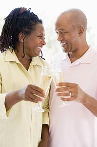 Couple toasting champagne and smiling