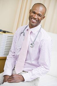A Doctor Sitting On A Hospital Bed