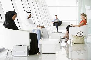 Airline passengers waiting in departure gate