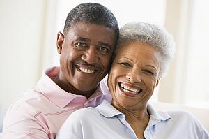 Couple relaxing in living room and smiling