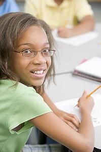 Student in class writing (selective focus)