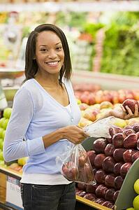 Woman shopping for apples at a grocery store