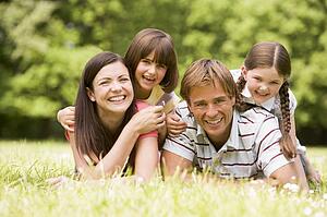 Family outdoors smiling