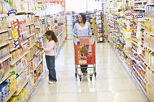 Mother and young daughter shopping at a grocery store