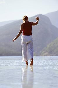 Woman outdoors walking on water in scenic location