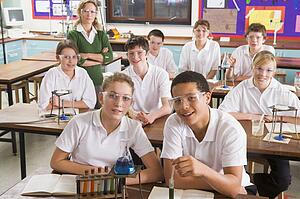 Students performing science experiments in classroom