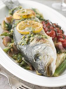 Whole Roasted Sea Bass with Fennel Lemon Cherry Vine Tomatoes and Salsa Verde