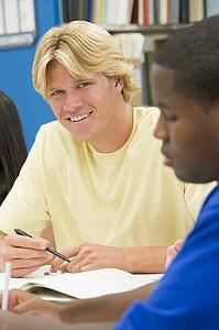 Three people in library studying (selective focus)