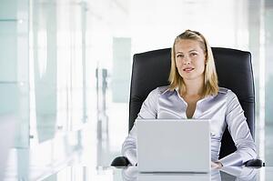 Businesswoman in office with a laptop