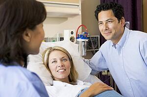 Doctor Talking To Pregnant Woman And Her Husband