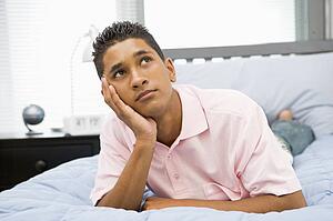 Teenage Boy Lying On Bed