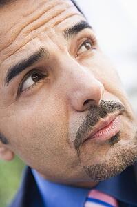 Businessman's face outdoors (selective focus)